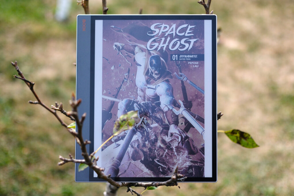 Boox Tab X C with Space Ghost comic on screen while device is suspended in a pear tree