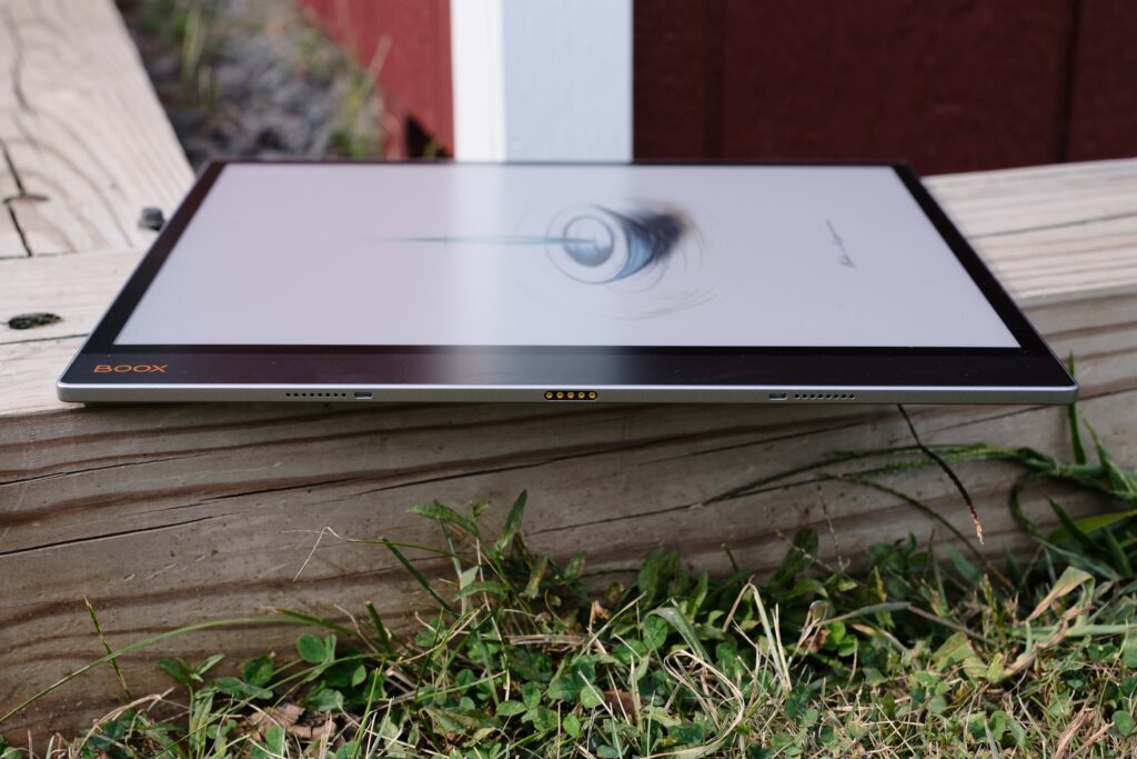 Boox Tab X C laying on wood while showing pogo pins