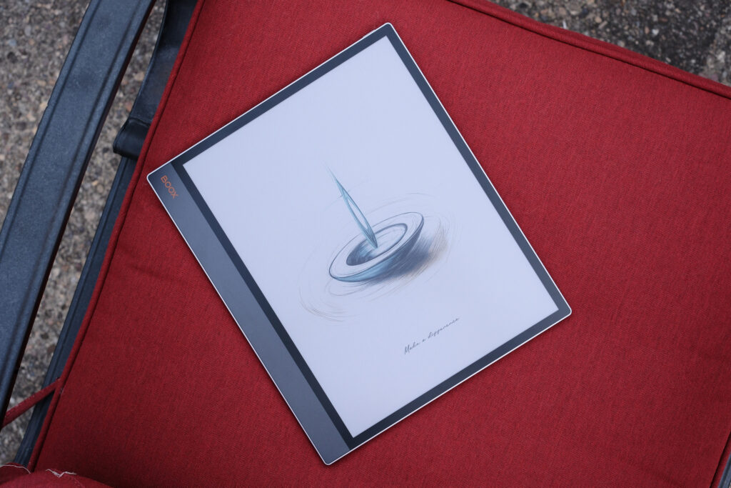 Boox Tab X C laying in red chair showing sleep screen