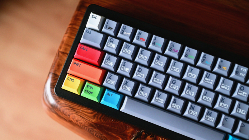 KAT Retrobytes Keycaps render showing colorful caps on board as it sits on wood table