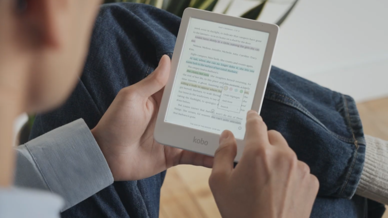 Kobo Clara Colour in white held in hand while being read