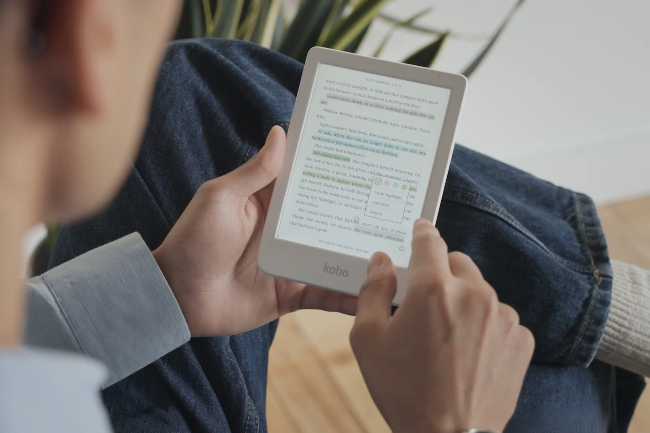 Kobo Clara Colour in white held in hand while being read