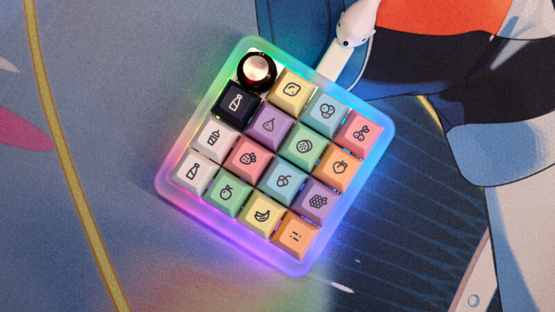 Vault 16 macropad sitting on deskmat with LEDs on