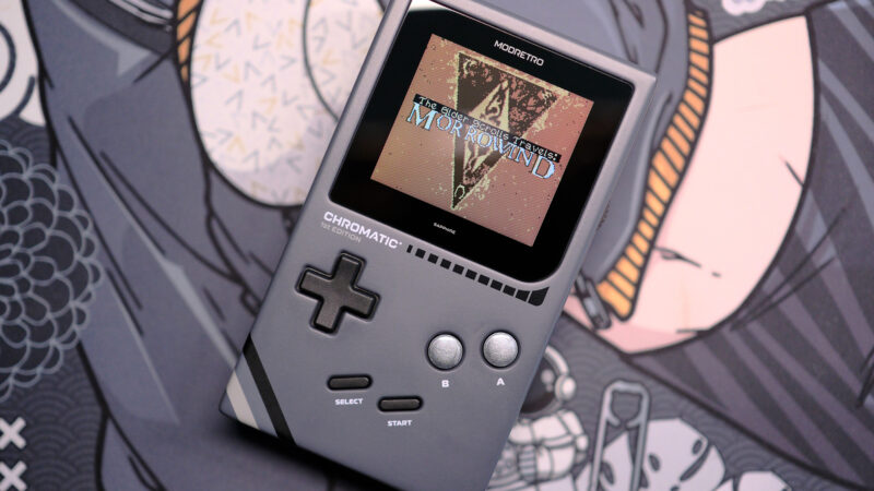 Modretro Chromatic laying on deskmat with The Elder Scrolls Travels: Morrowind on the screen