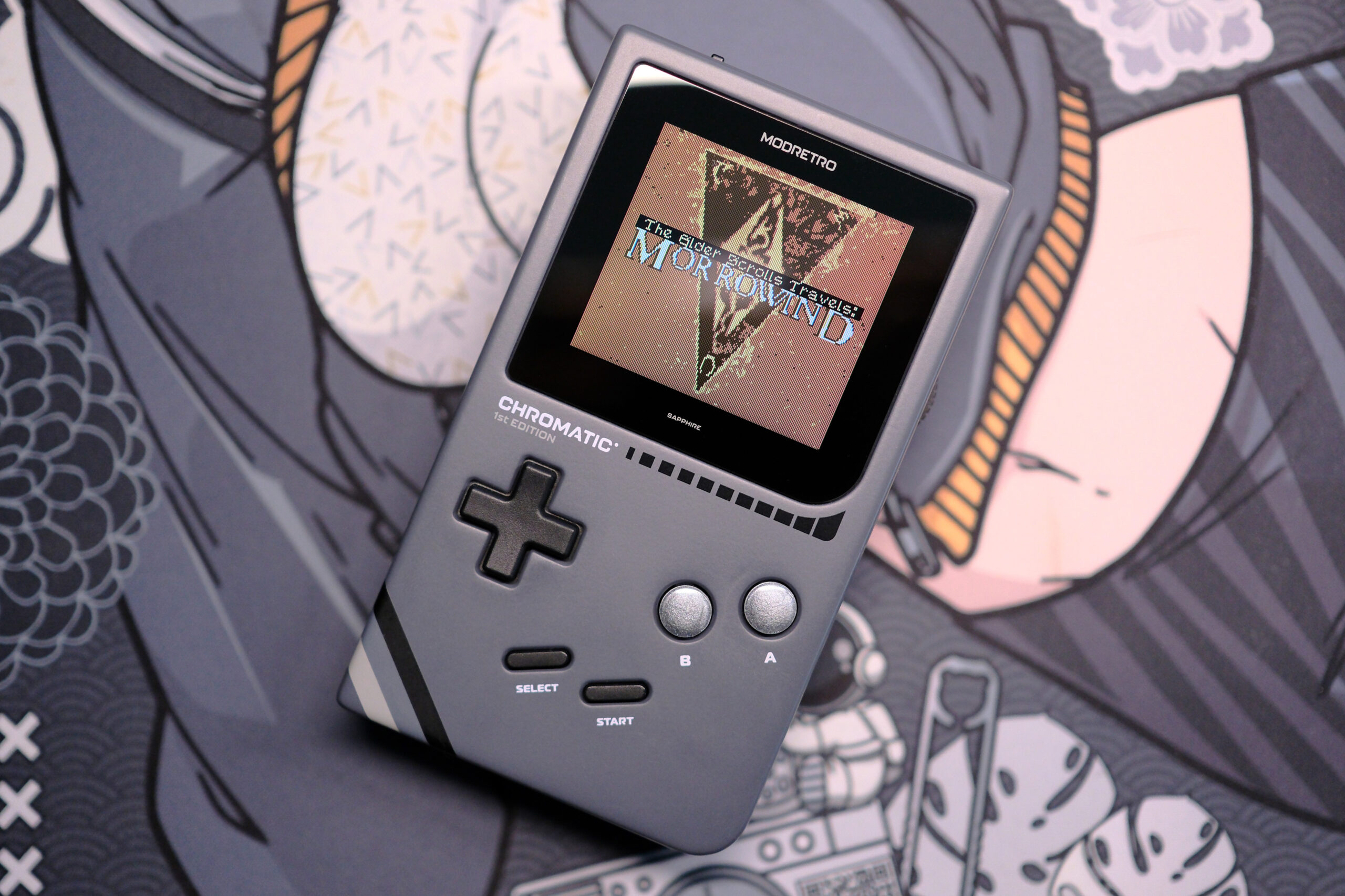 Modretro Chromatic laying on deskmat with The Elder Scrolls Travels: Morrowind on the screen