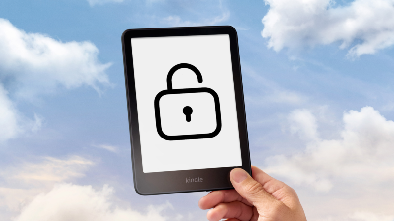Hand holding a Kindle with an open lock icon on it in front of a cloudy sky