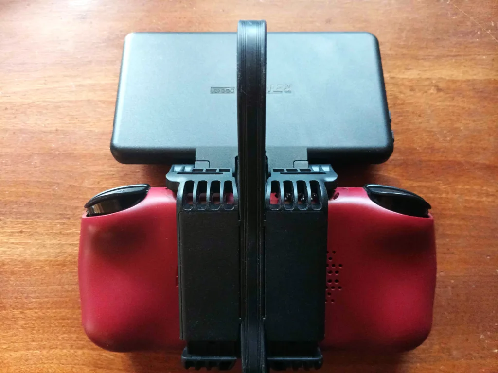 A top down view of the back of the Retroid Pocket Mini with the Dual Screen attachment with the lid open.