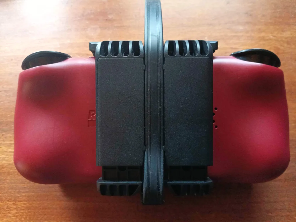 A picture of the dual screen attachment from the back with the lid closed, showing how much excess the included USB-C cable has.