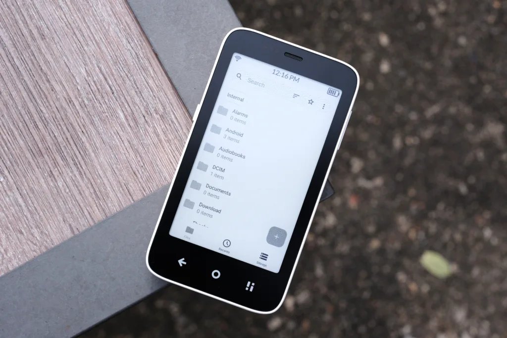 Mudita Kompakt on edge of table screen up