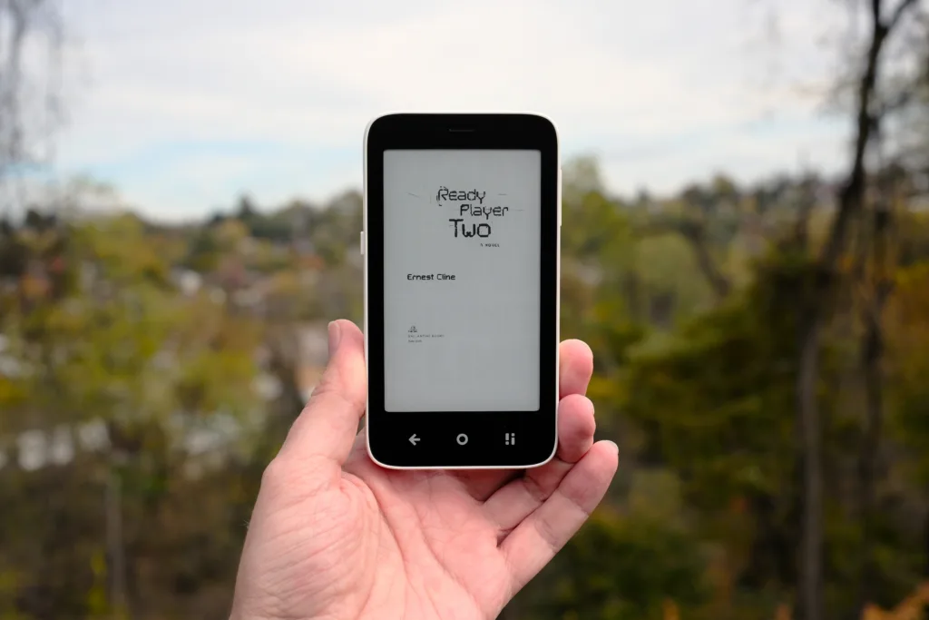 Mudita Kompakt held in hand reading epub