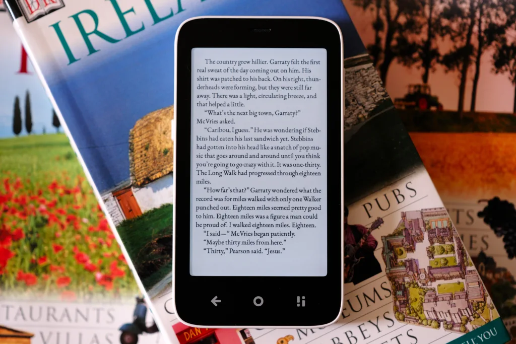 Mudita Kompakt laying on pile of books