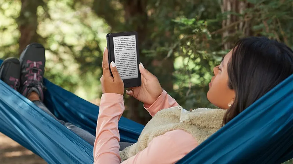 Woman in hammock reading a black Kindle Basic