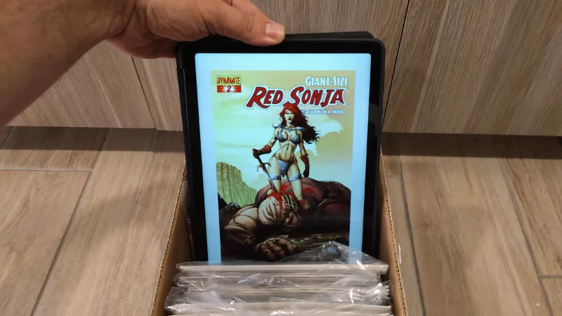 Samsung Galaxy A9+ with cover of Red Sonja comic book on screen