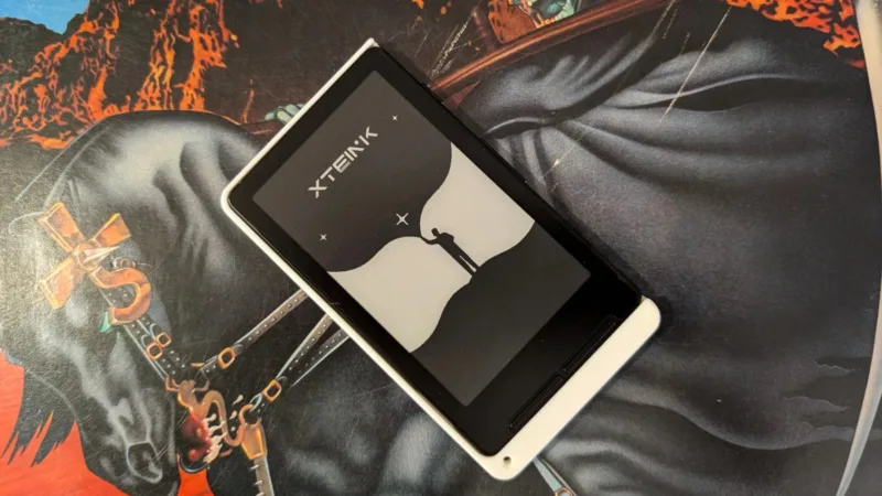 Xteink x4 on deskmat with death