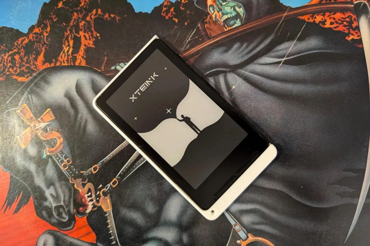 Xteink x4 on deskmat with death