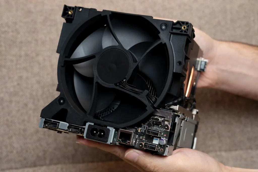 A picture of the back of the Steam Machine without it's case, revealing a massive fan and heat sink that's about two thirds of the six cubic inches of the device.
