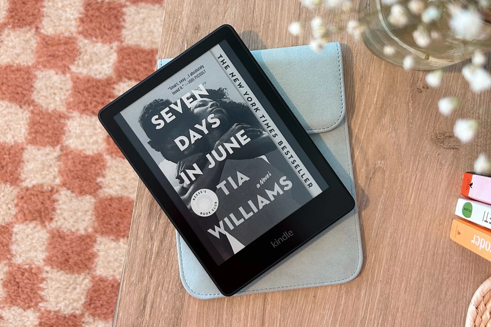 Kindle sitting on top of case on desk