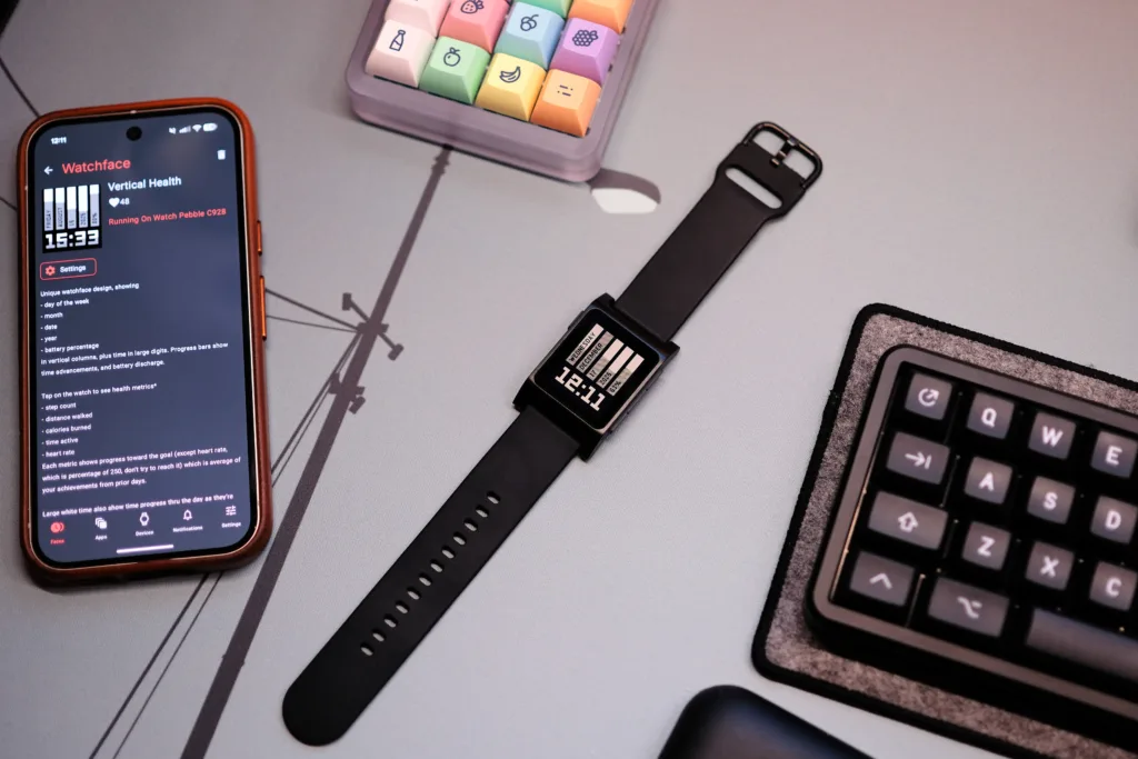 Pebble 2 Duo next to phone with app running