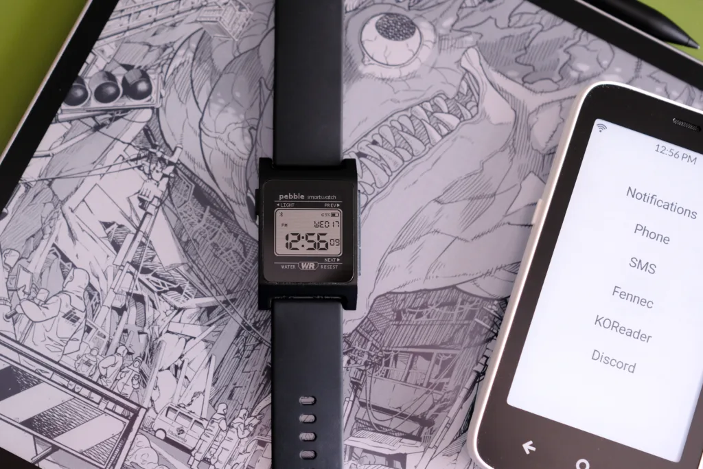 Pebble 2 Duo resting on top of Boox E Ink table with E Ink phone next to it
