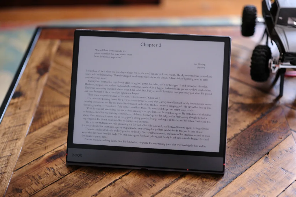 Boox Air5 C with case propping it up on a table showing text on the screen