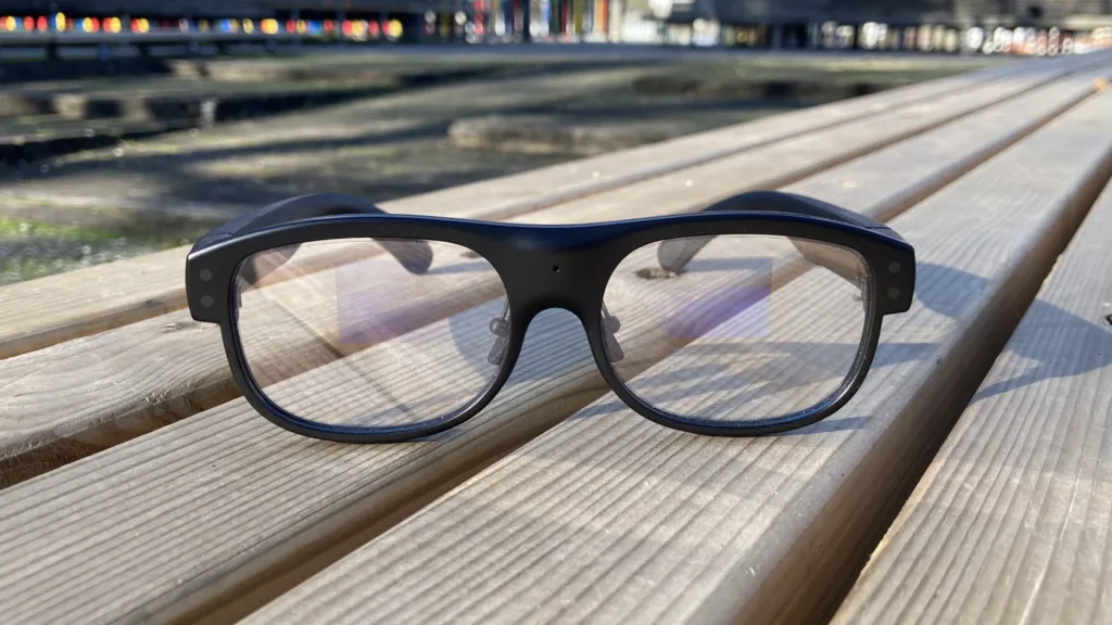 Leion Hey2 Translation Glasses laying on wood with lenses toward viewer