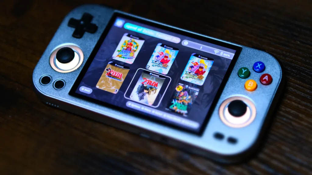 A picture of the RG 477m running the ES-DE front-end, displaying Gamecube games like Super Mario Sunshine, Tales of Symphonia, and the Legend of Zelda: The Wind Waker HD.