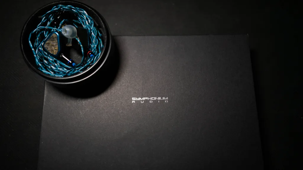Symphonium Titan inside its case, on top of its retail box lid