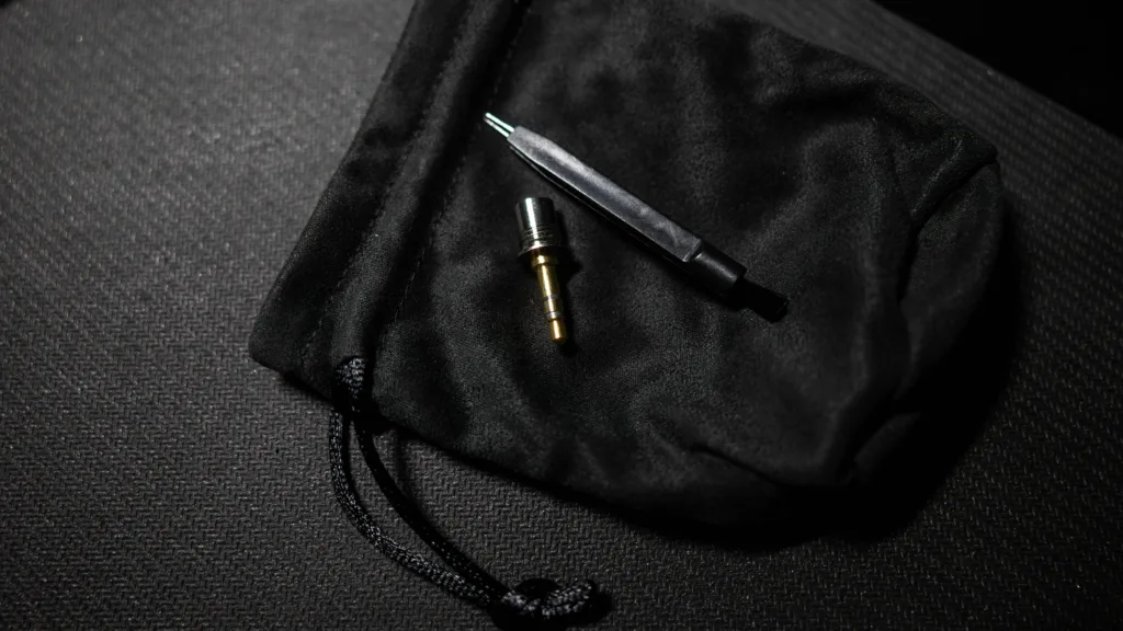 Symphonium Titan's cable's 3.5mm plug and its cleaning tool