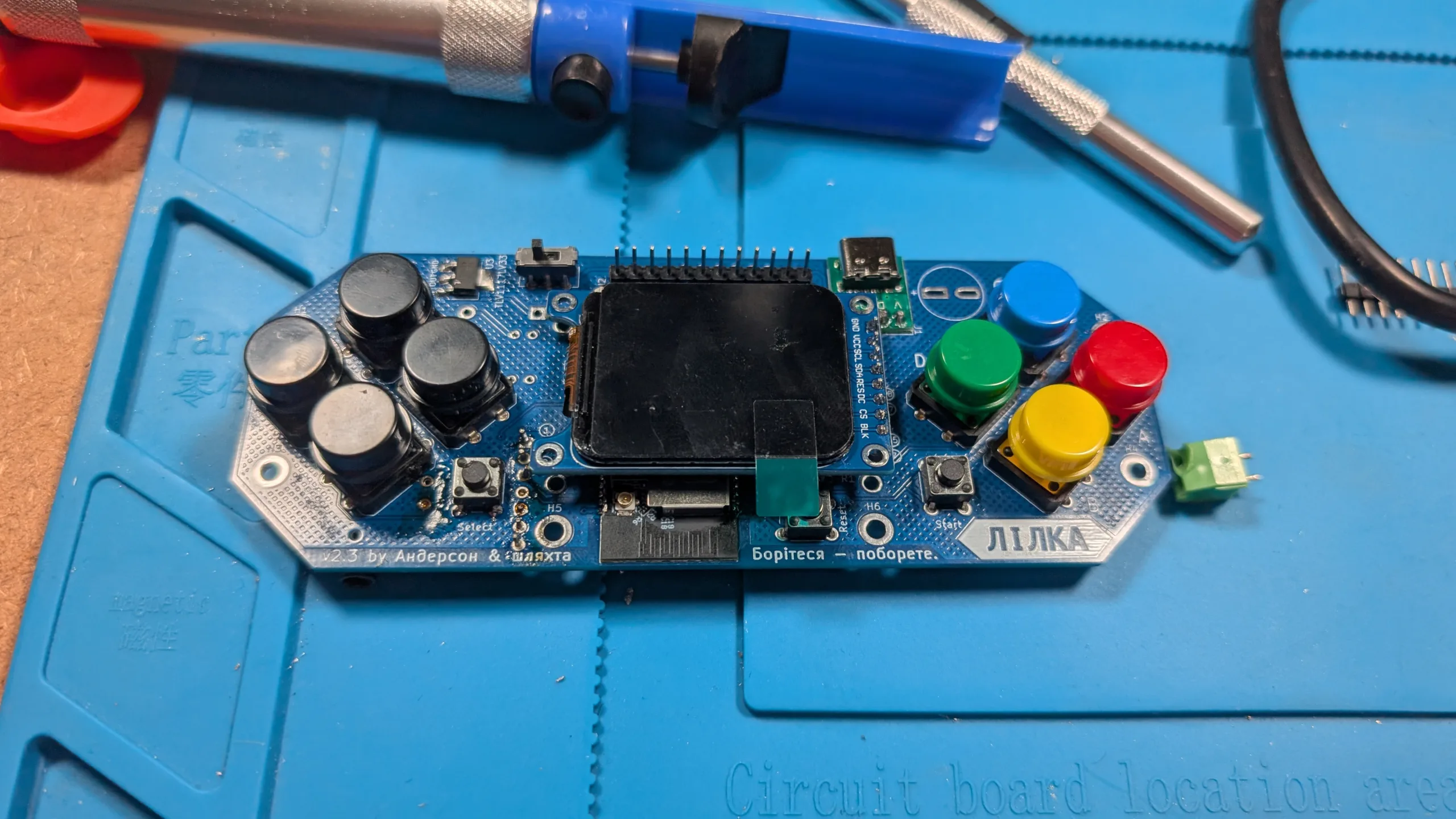 assembled Lilka on a blue soldering mat with other assorted tools