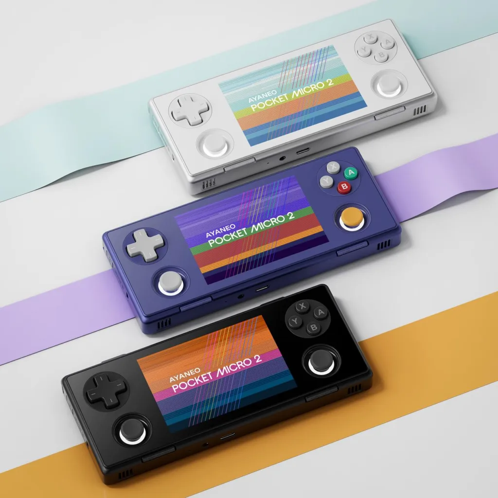 A picture showing all 3 color variants of the Ayaneo Pocket Micro 2. The white is on top, the stardust purple in the middle, and the black on the bottom.