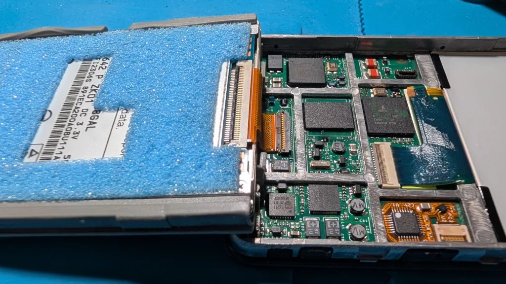 hard drive of iPod Video folded out from the frame of the iPod
